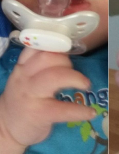 Hand eines Babys greift nach dem Schnuller